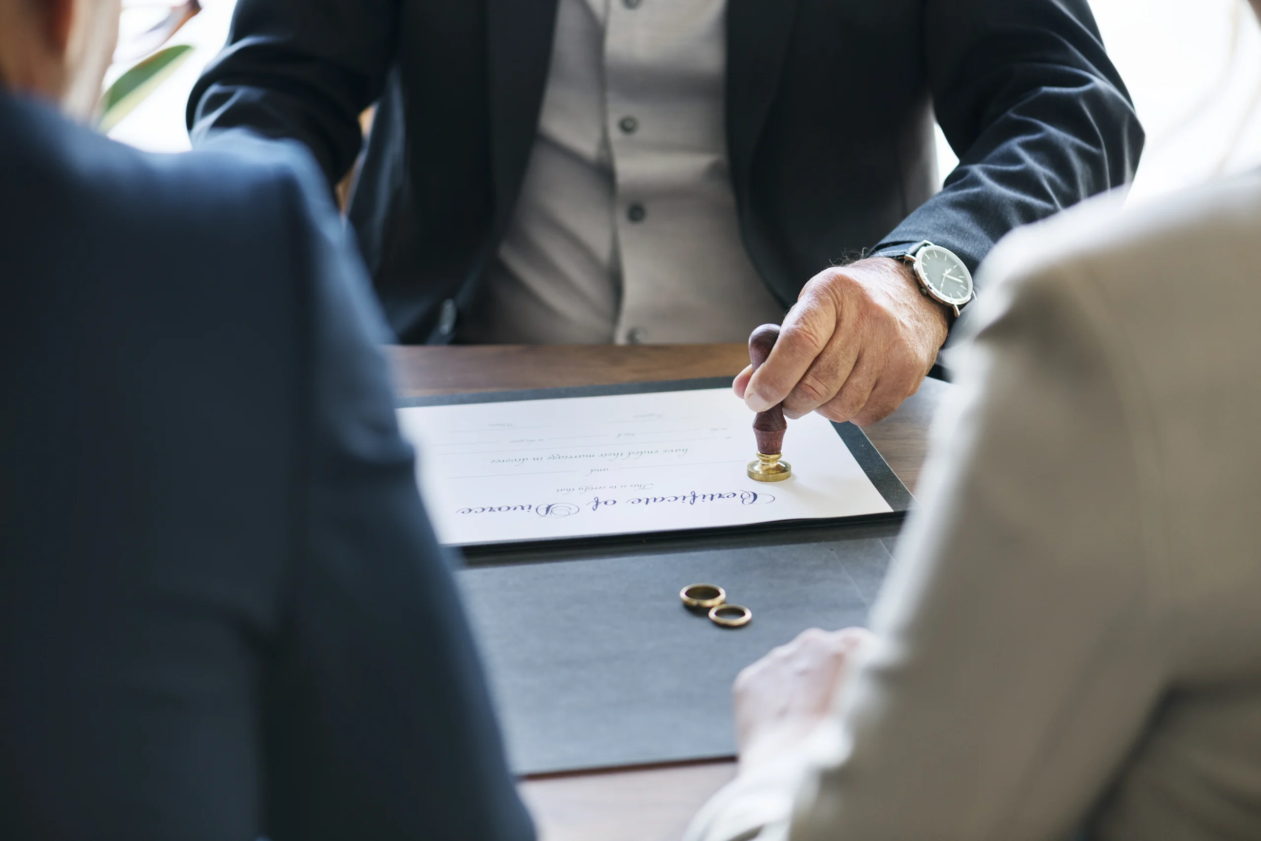 signing-divorce-papers-at-a-wood-desk-2026-03-18-13-49-24-utc