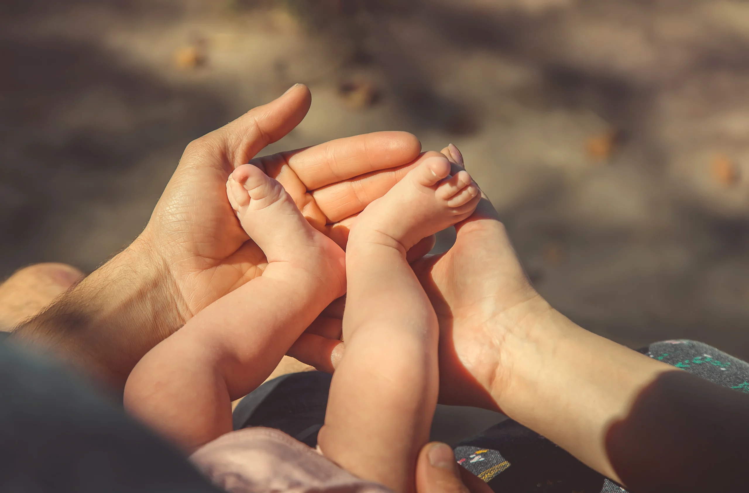 tiny-infant-feet-held-by-loving-adult-hands-2026-01-06-10-09-09-utc